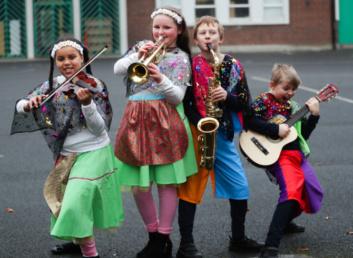 Four children playing instruments funded by the Music Capital Scheme